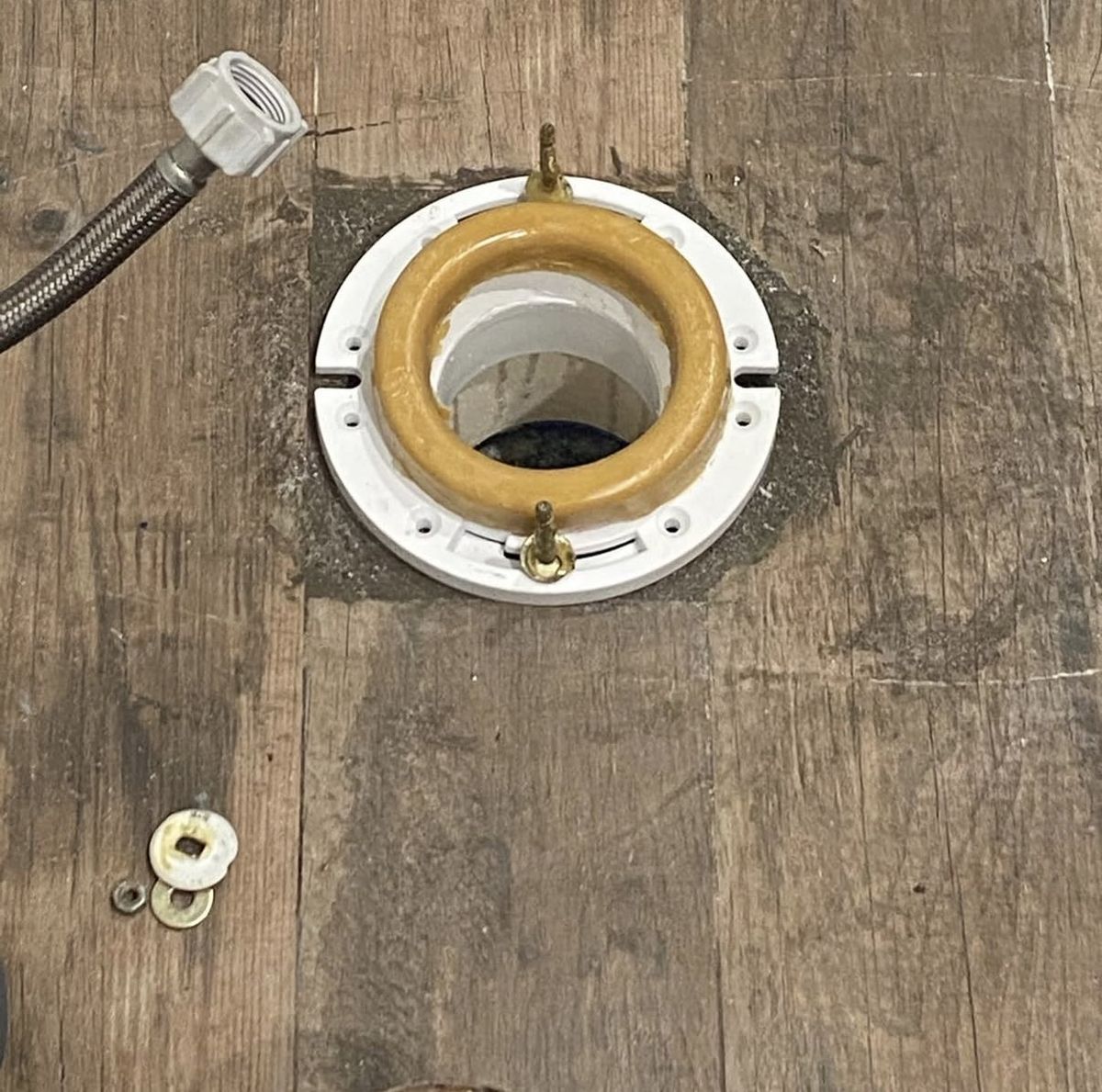 After: new PVC toilet flange with wax ring and bolts