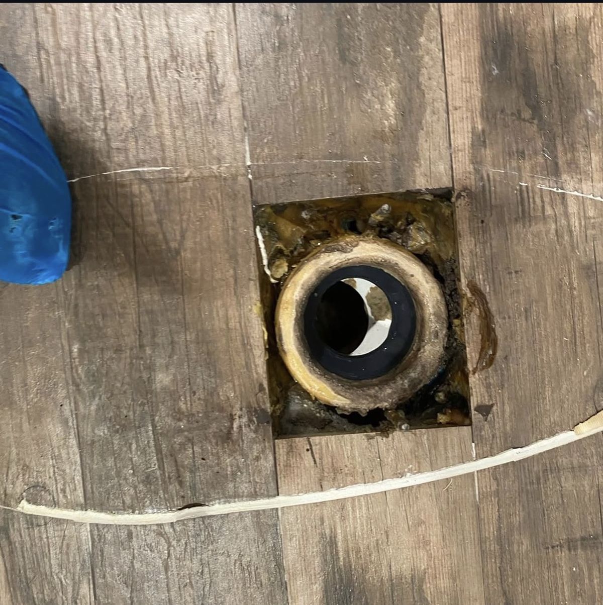 Before: old, corroded toilet flange on the bathroom floor